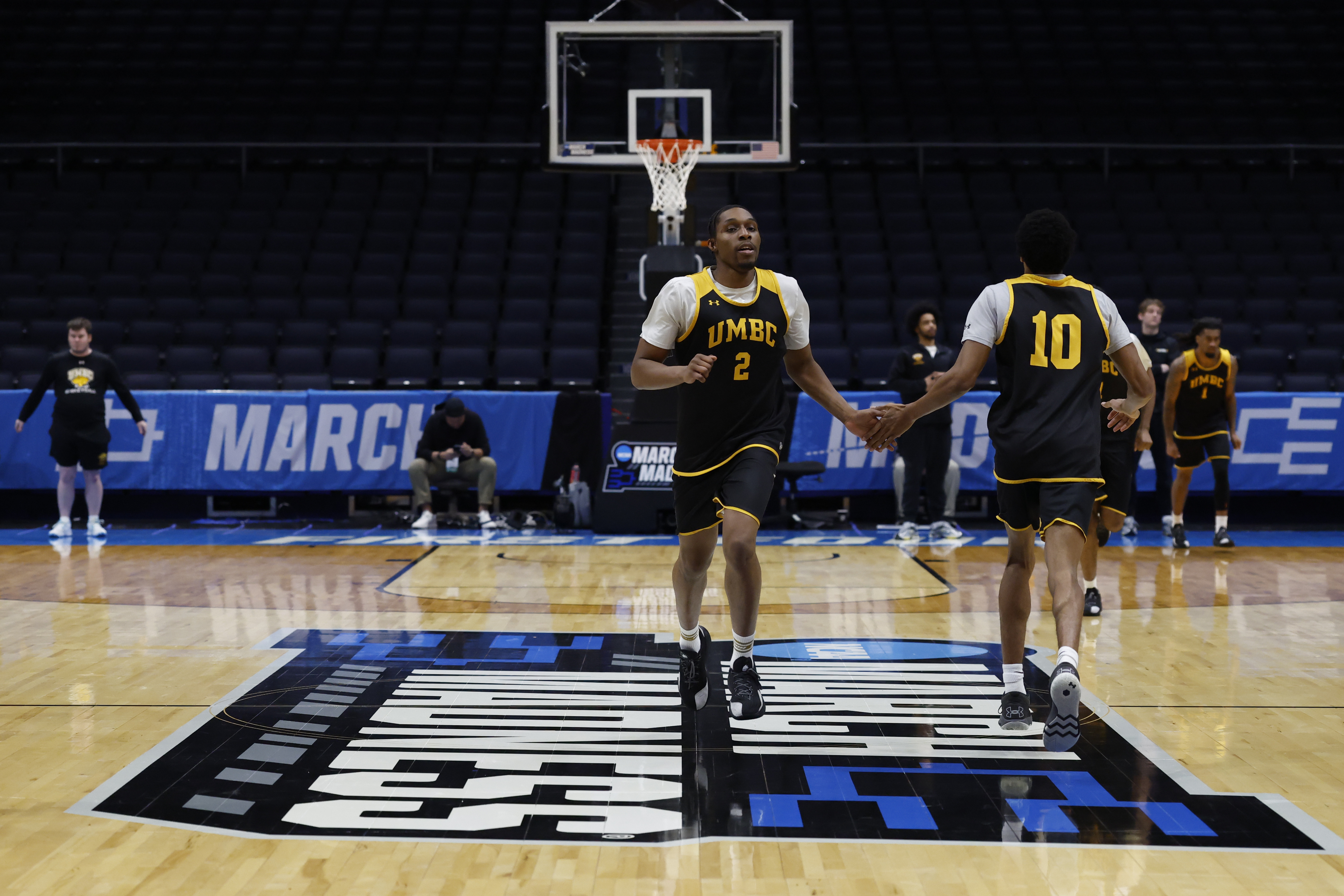 UMBC forward Josh Odunowo (2) high-fives forward Paul Greene (10) on the court during a practice session ahead of the first four of the men's 2026 NCAA Tournament as we look at our UMBC vs. Howard prediction