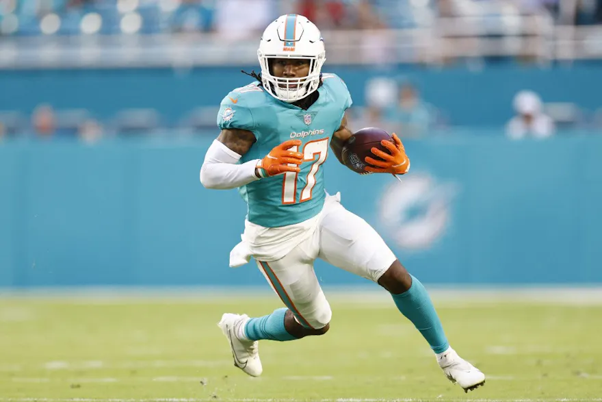 Jaylen Waddle of the Miami Dolphins runs with the ball during a preseason game against the Atlanta Falcons at Hard Rock Stadium on August 21, 2021 in Miami Gardens, Florida.