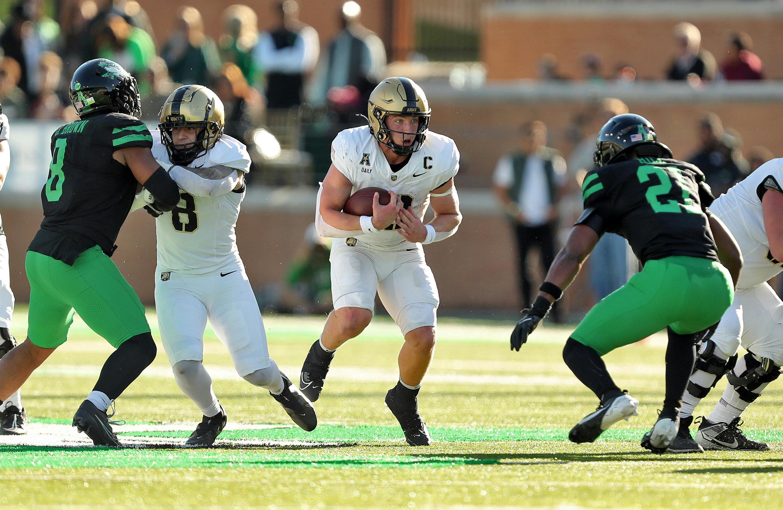 Army quarterback Bryson Daily carries the ball against North Texas. Army is part of our Week 13 college football predictions.