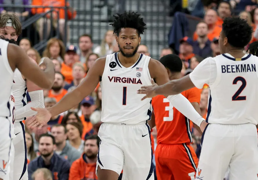 Jayden Gardner #1 of the Virginia Cavaliers is congratulated by teammates after scoring a basket and drawing a foul against the Illinois Fighting Illini in the first half of the championship game of the Continental Tire Main Event basketball tournament at