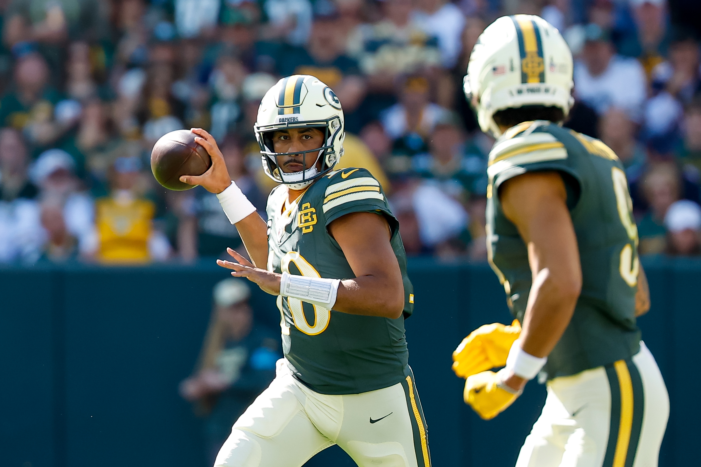 Pictured: Jordan Love throwing a pass to Christian Watson as we break down our Cowboys vs. Packers Prediction. Photo by Darren Lee/Cal Sport Media/Sipa USA.