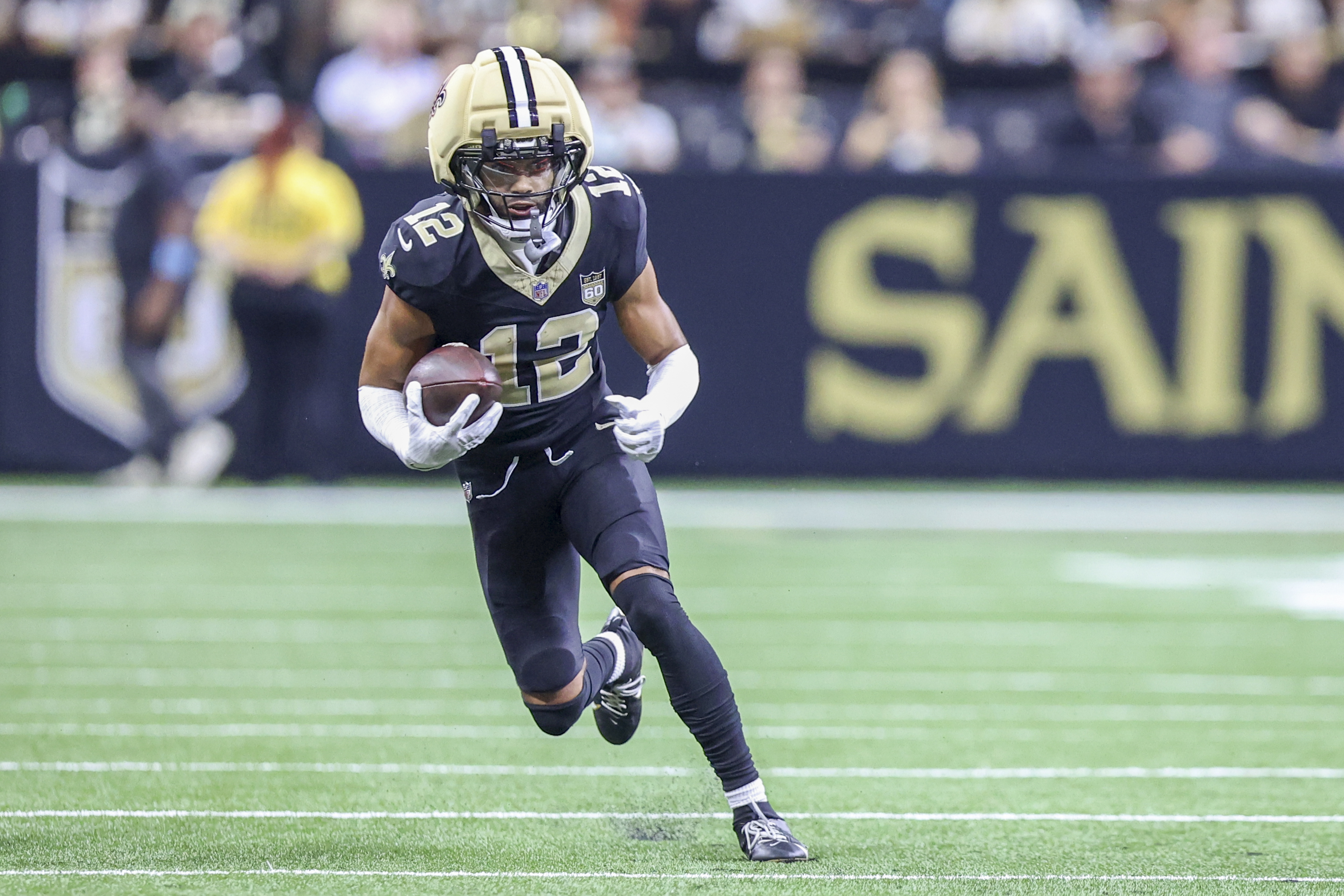 New Orleans Saints wide receiver Chris Olave tries to gain some yards as we make our best Falcons vs. Saints touchdown predictions