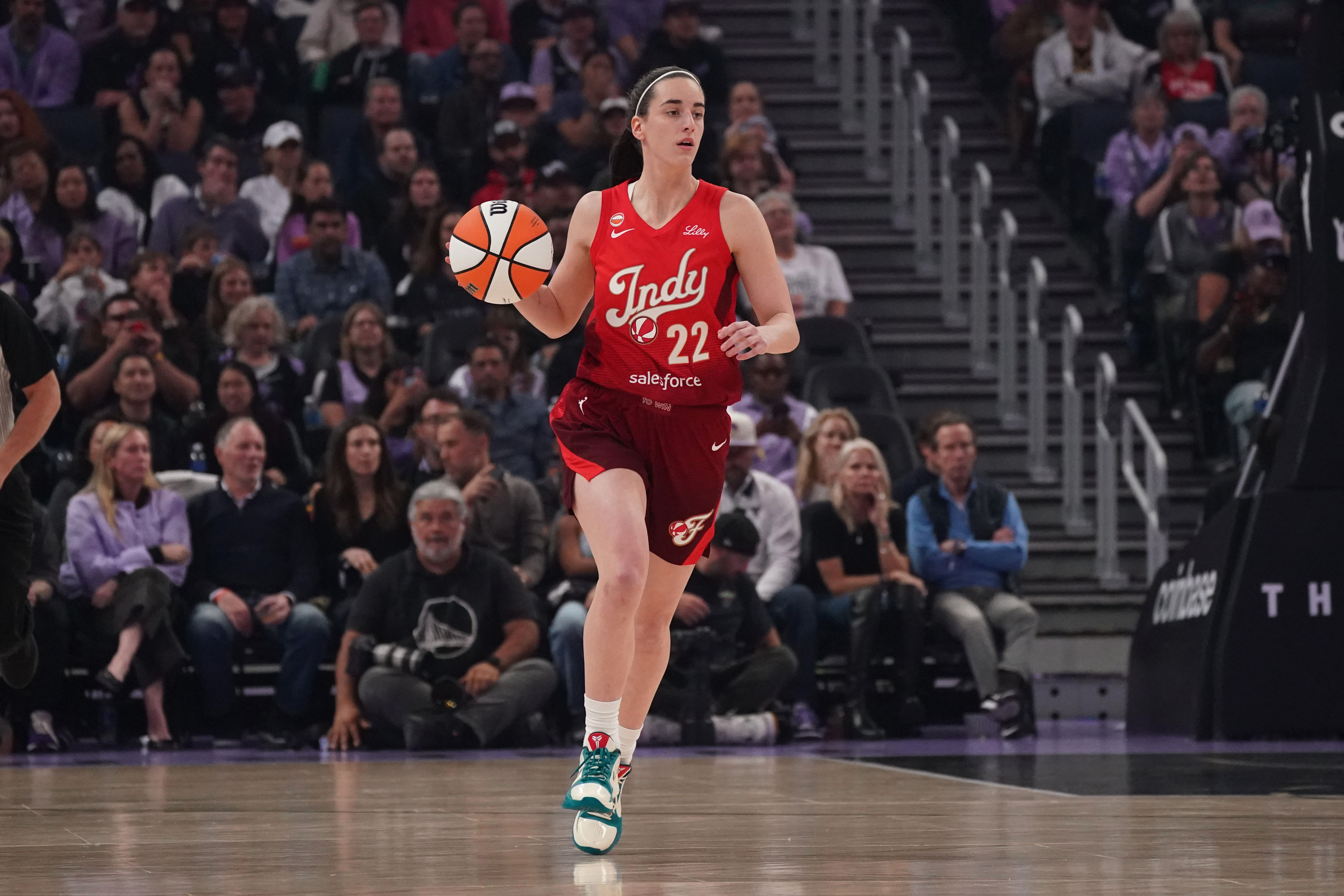 Indiana Fever guard Caitlin Clark (22) dribbles upcourt as she is featured in our Dream vs. Fever prediction.