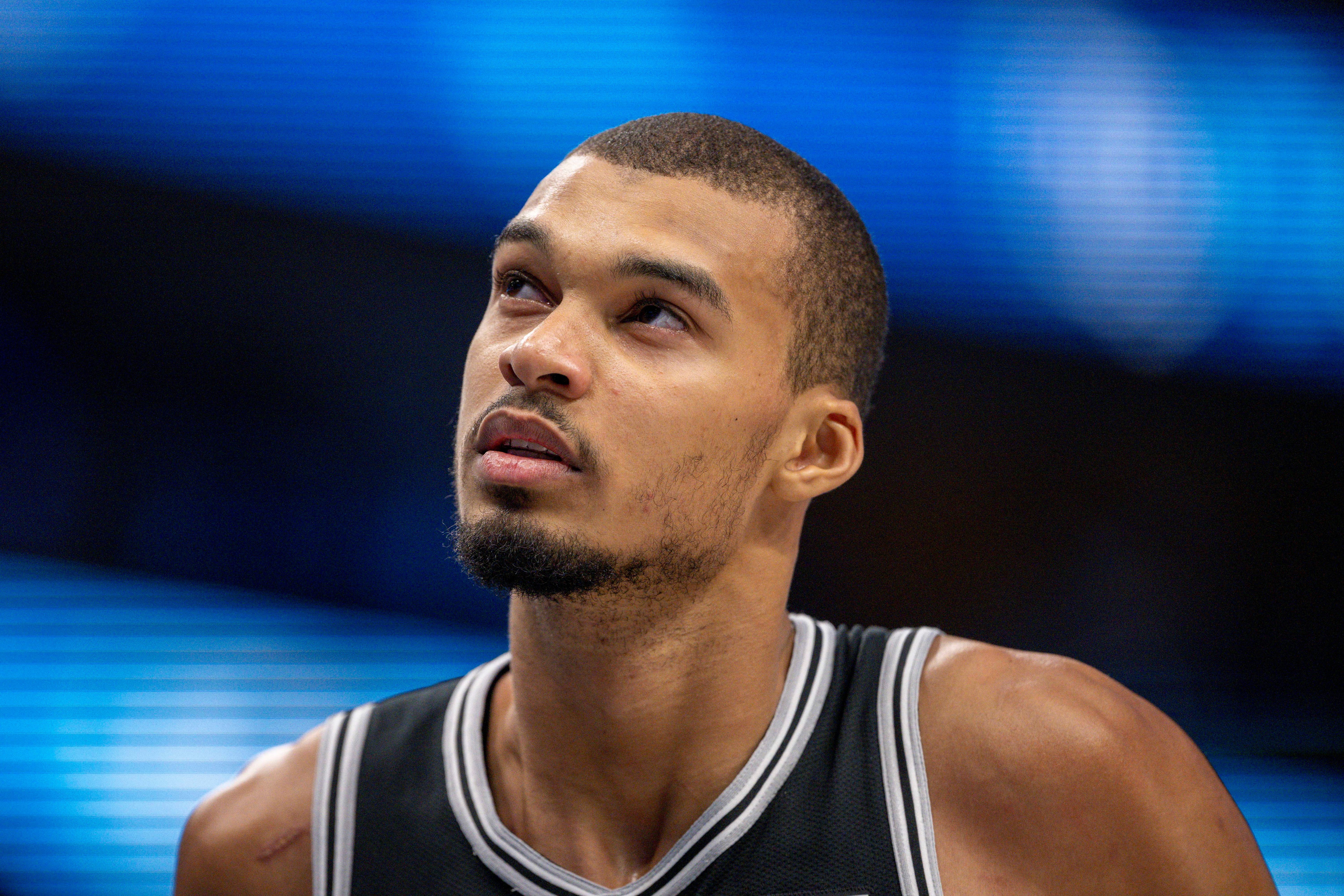 San Antonio Spurs forward Victor Wembanyama (1), seen here looking on during a game, is featured in our NBA player props tonight.