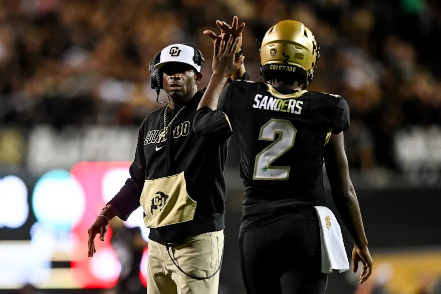 Head coach Deion Sanders of the Colorado Buffaloes celebrates with quarterback Shedeur Sanders after a fourth-quarter touchdown against the Colorado State Rams as we look at BetMGM's problem gambling initiative in Colorado.