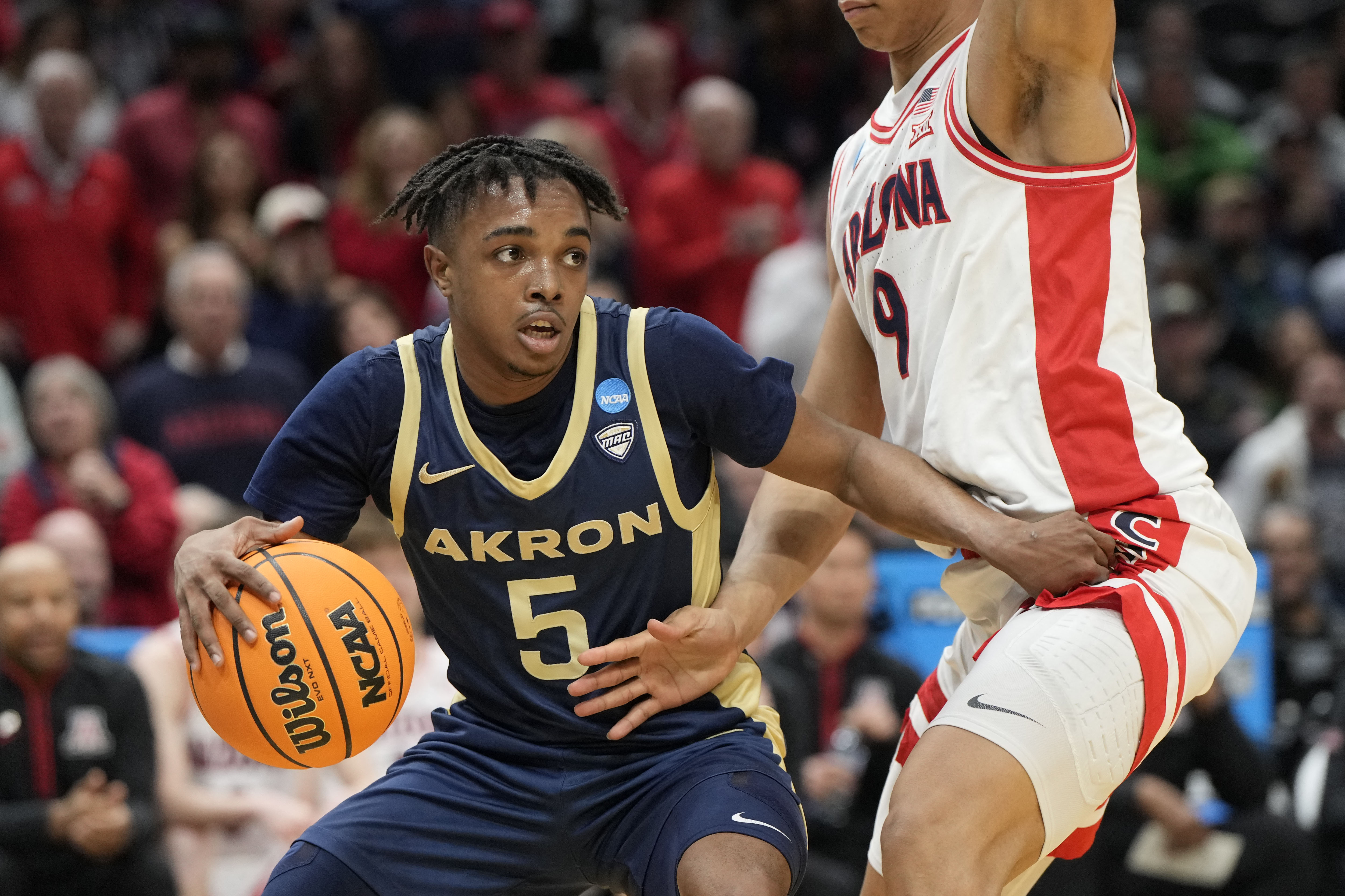  Akron Zips guard Tavari Johnson (5) dribbles the ball as we break down our Toledo vs. Akron prediction.