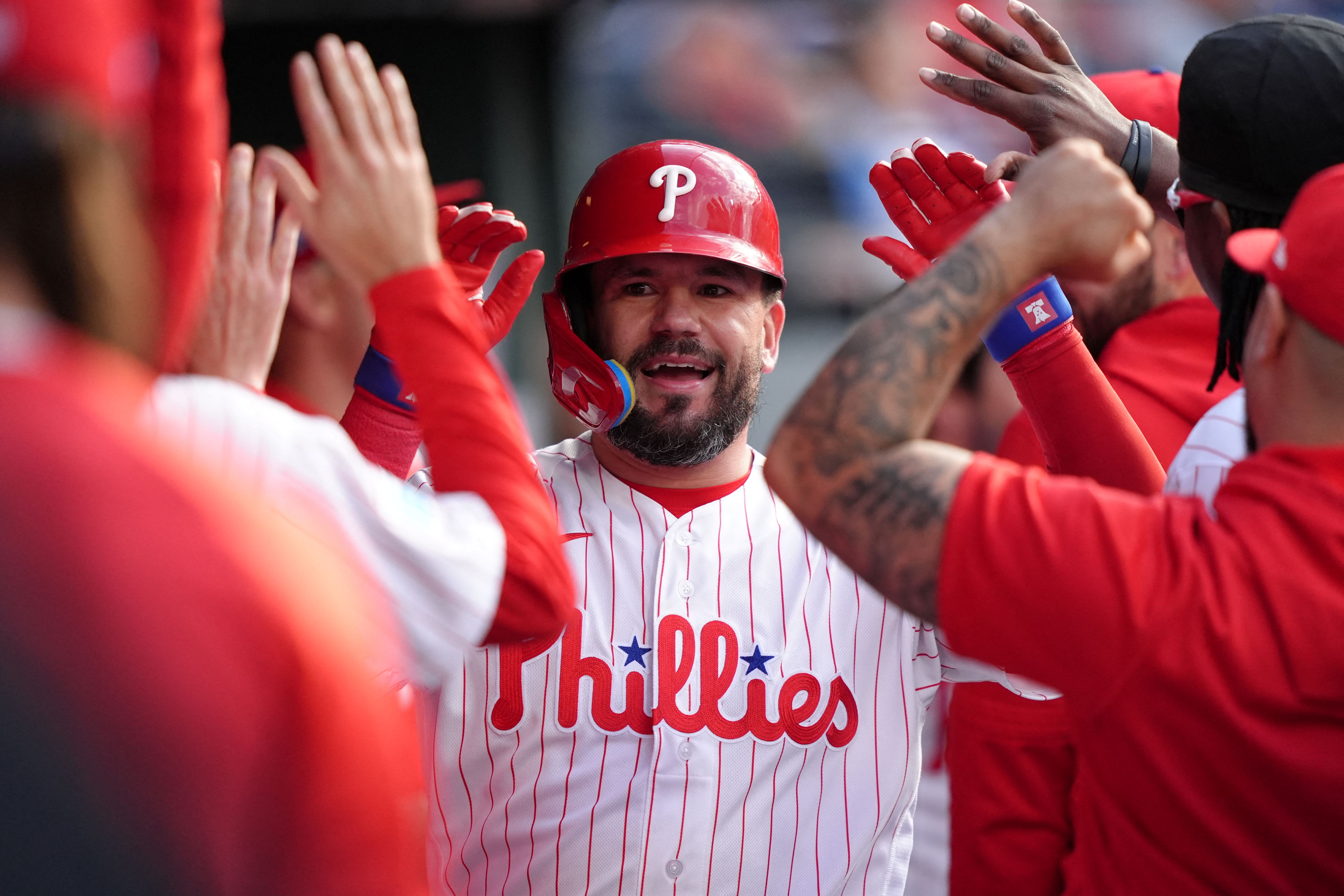 Philadelphia Phillies designated hitter Kyle Schwarber celebrates with teammates after hitting a home run, and he's featured in the Padres vs. Phillies win probability.