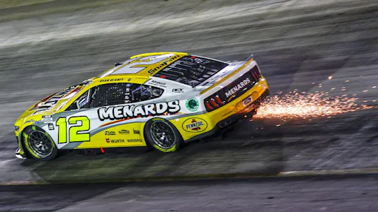 Ryan Blaney, driver of the #12 Menards/Pennzoil Ford, drives with sparks after an on-track incident during the NASCAR Cup Series Bass Pro Shops Night Race at Bristol Motor Speedway on Sept. 17.