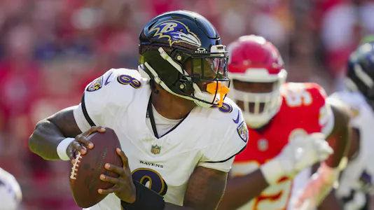 Baltimore Ravens quarterback Lamar Jackson - who's featured in our NFL expert picks for Week 8 - rolls out to pass.