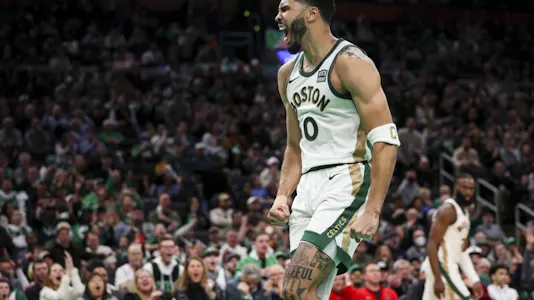 Jayson Tatum #0 of the Boston Celtics reacts after a dunk as we look at our top Mavericks vs. Celtics NBA player props for Friday