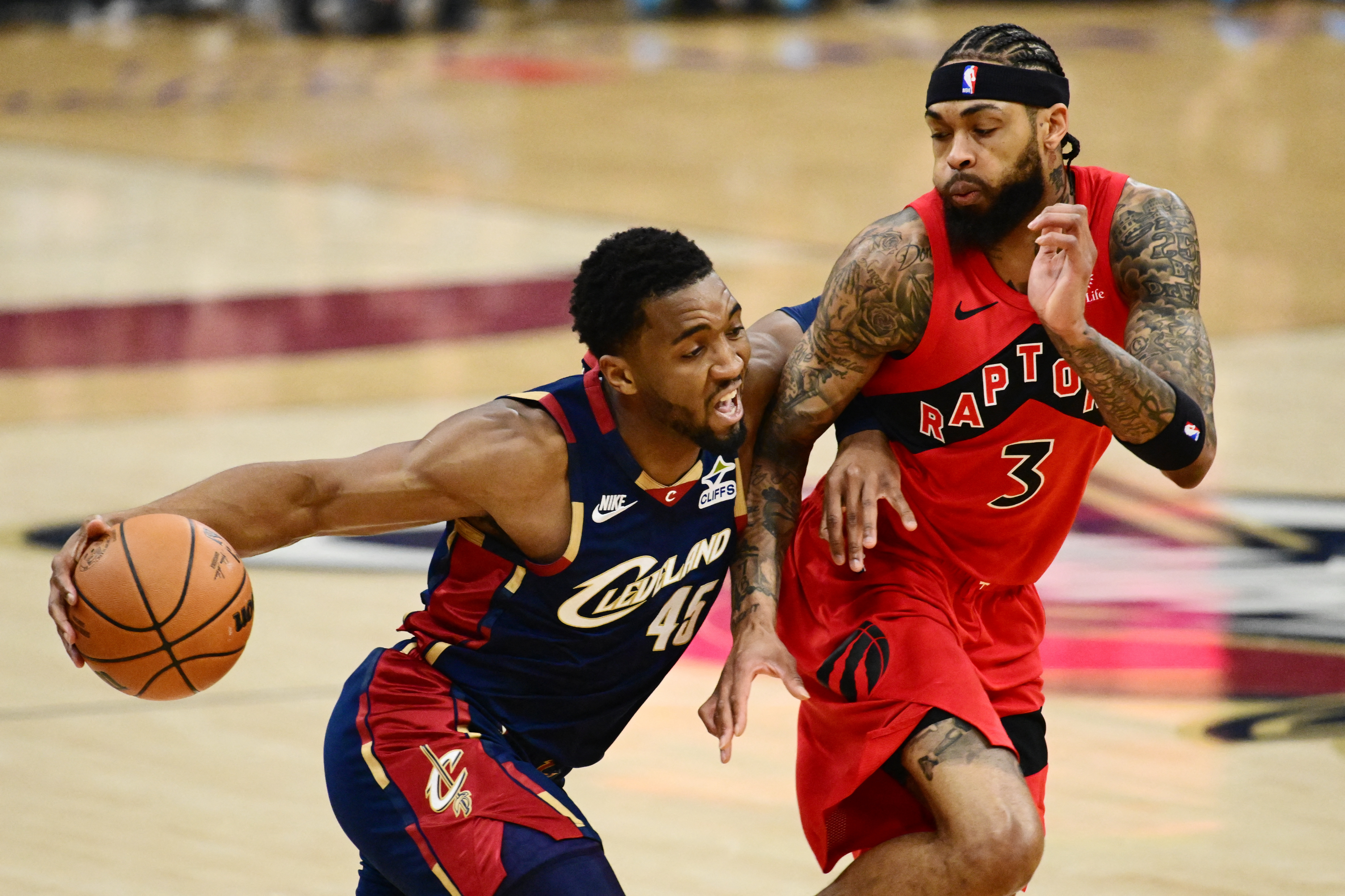 Cleveland Cavaliers guard Donovan Mitchell drives to the basket against Toronto Raptors forward Brandon Ingram as we provide our Raptors vs. Cavaliers player props.