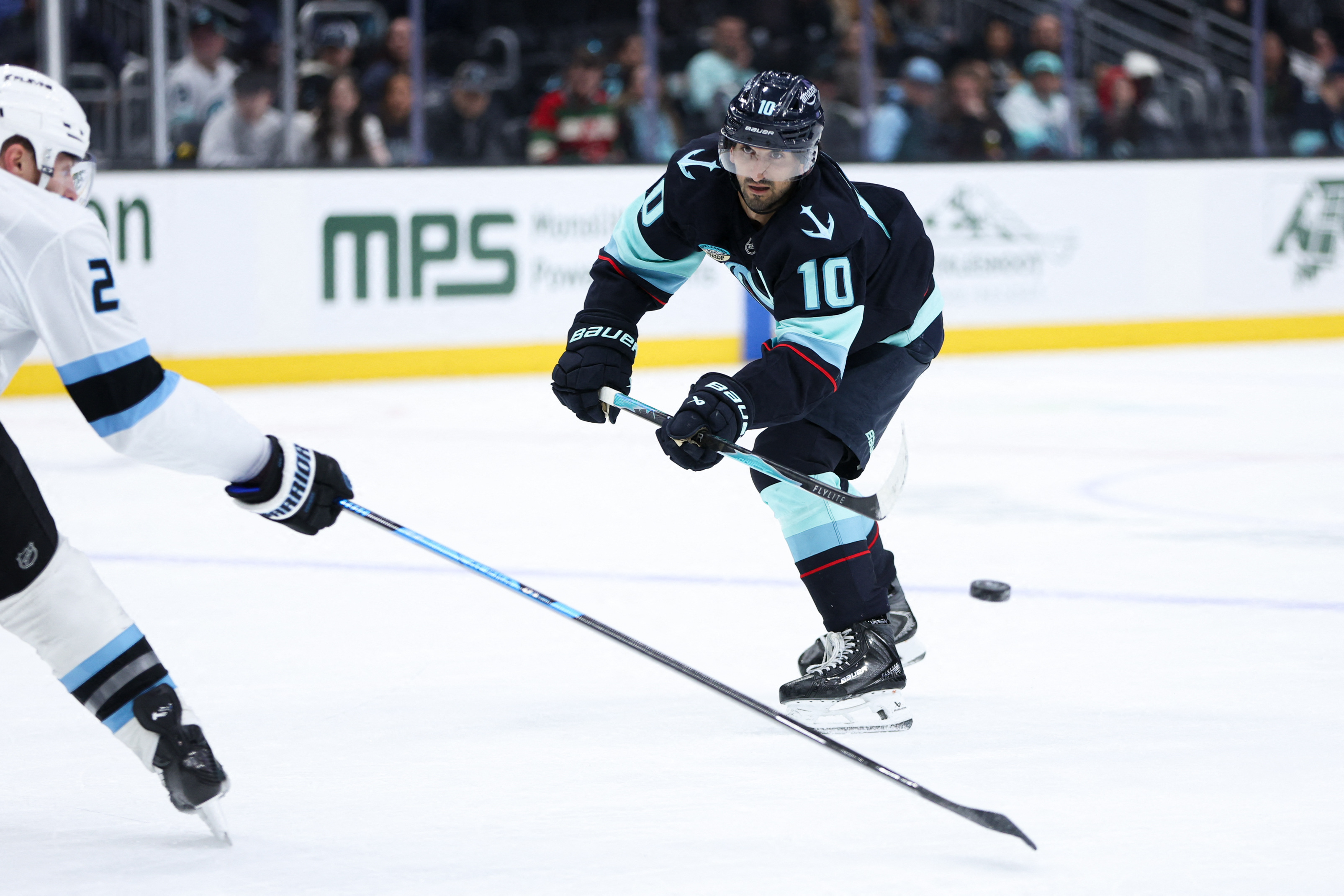 Seattle Kraken center Matty Beniers (10) passes as we break down our Kraken vs. Avalanche prediction.