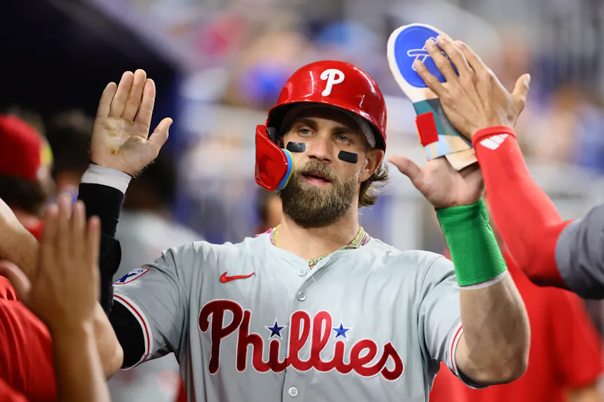 Philadelphia Phillies first baseman Bryce Harper celebrates with teammates after scoring against the Miami Marlins as we look at our Mets vs. Phillies prediction.