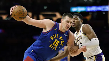 Nikola Jokic spins around Rui Hachimura of the Los Angeles Lakers at Crypto.com Arena. The Nuggets have the second shortest odds to win the NBA Finals.