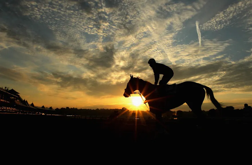 Horse and rider train as the sun rises at Saratoga Racetrack as we look at the deal between DraftKings and the NYRA.