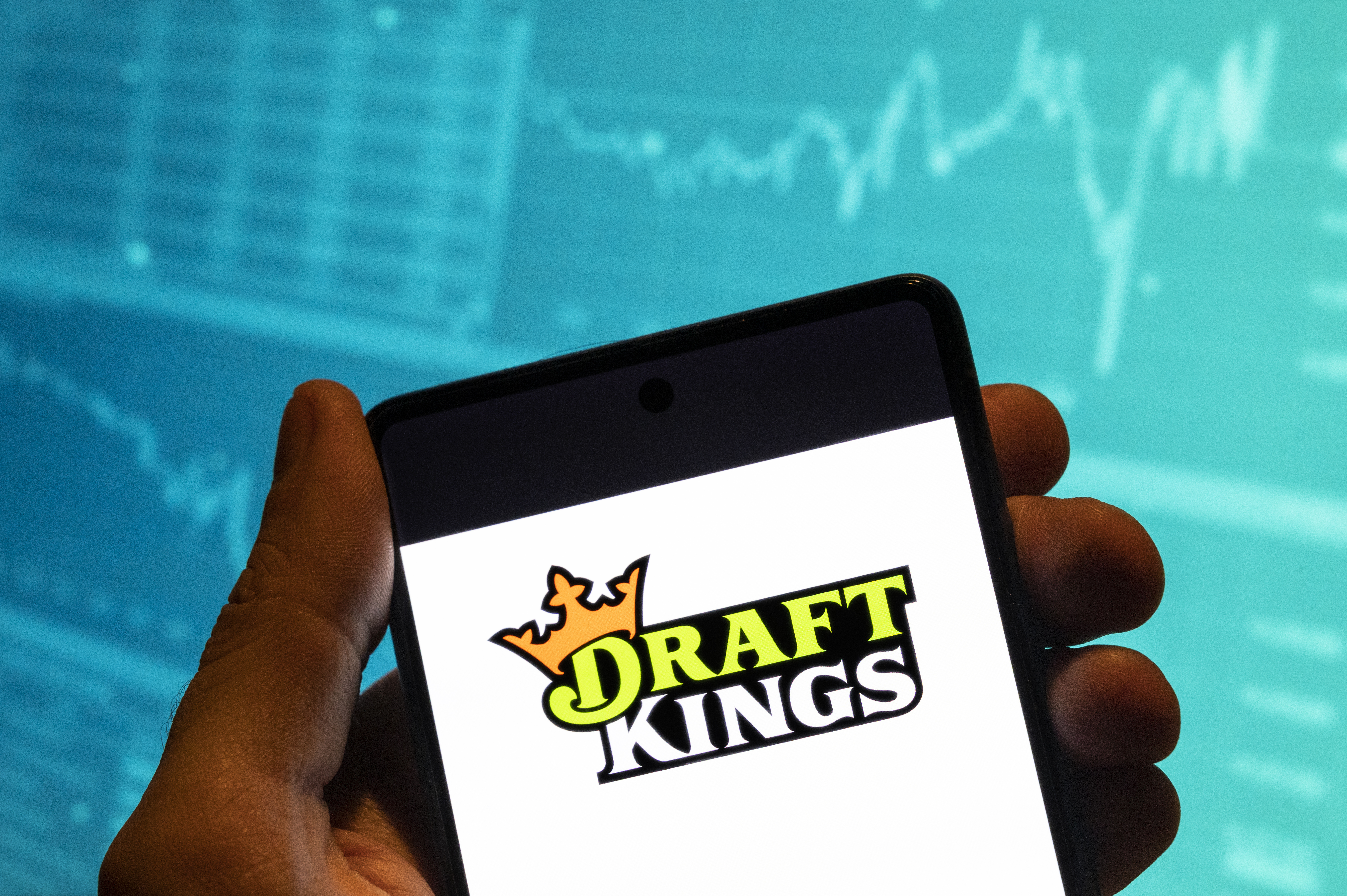 The DraftKings logo is seen displayed on a smartphone as we look at the launch of DraftKings Predictions