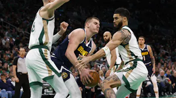 Nikola Jokic #15 of the Denver Nuggets tries to get away from Jayson Tatum #0 of the Boston Celtics as we break down the latest 2024 NBA championship odds to win the NBA Finals.