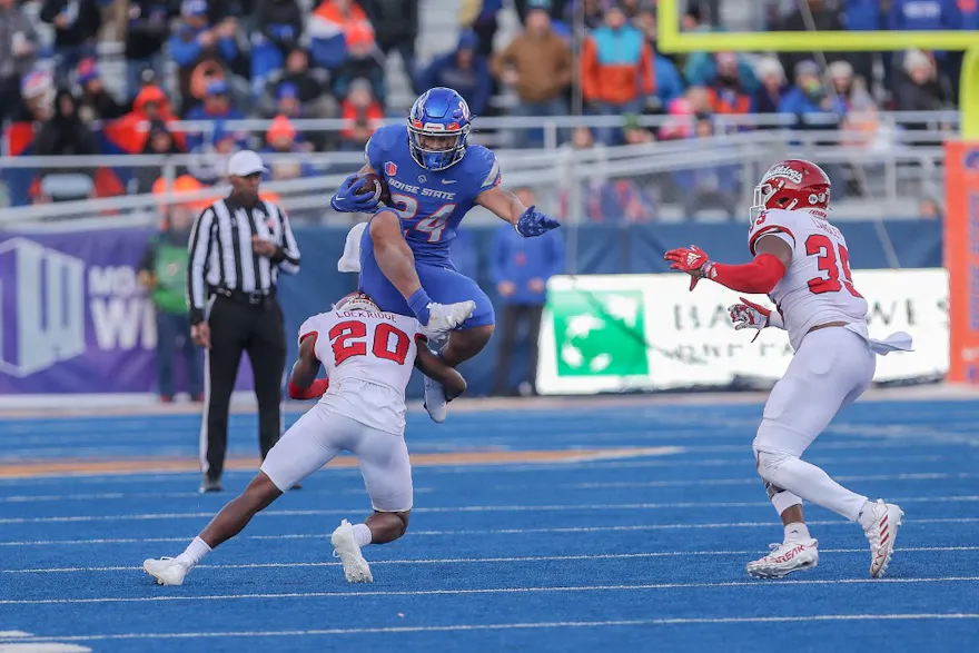 Running back George Holani of the Boise State Broncos hurdles as we share our best college football player props for the upcoming bowl weekend.