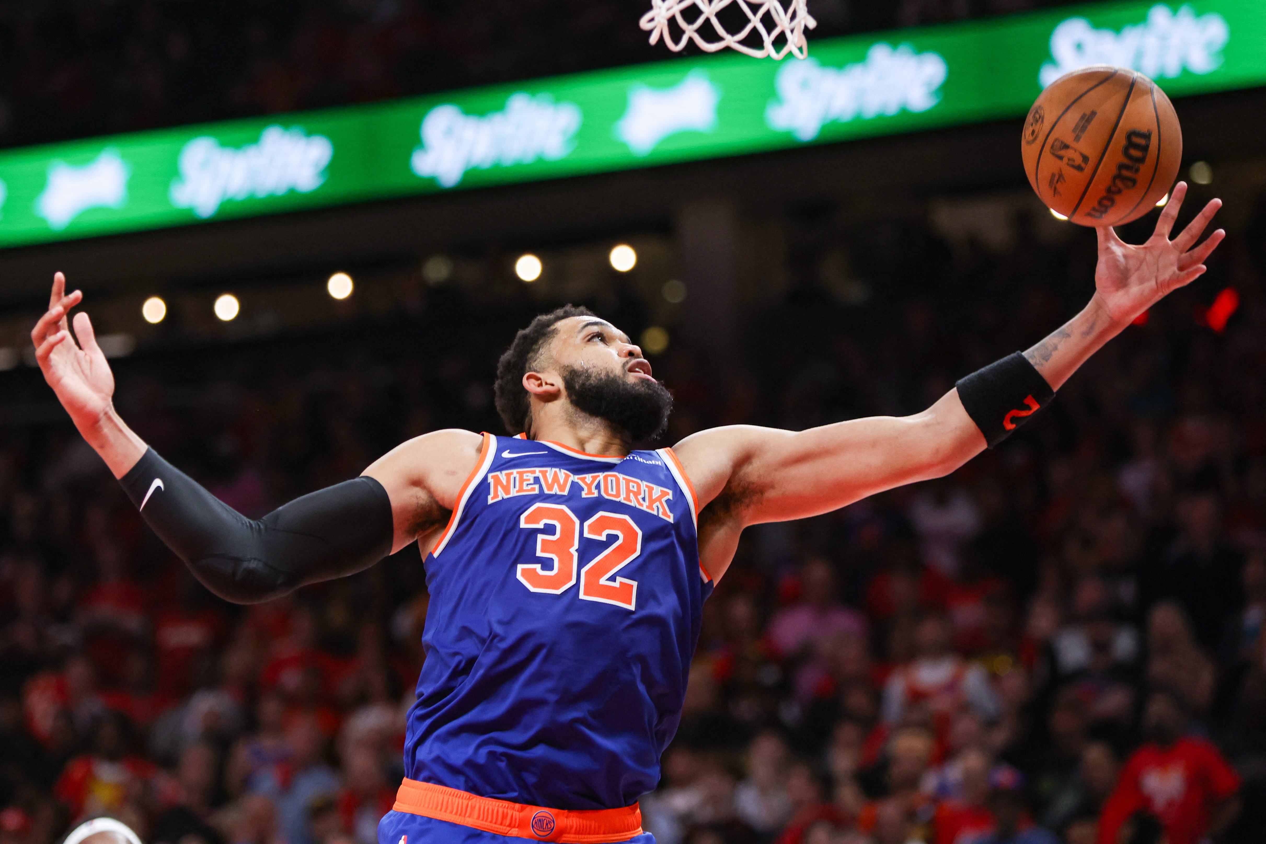New York Knicks center Karl-Anthony Towns (32) grabs a rebound as we break down our Knicks vs. Hawks Game 4 player props.