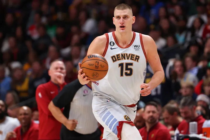 Nikola Jokic of the Denver Nuggets dribbles the ball in the first half of the game against the Phoenix Suns.