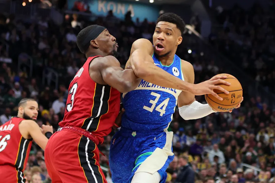 Giannis Antetokounmpo of the Milwaukee Bucks is defended by Bam Adebayo of the Miami Heat as we look at our Bucks-Grizzlies NBA prop picks.