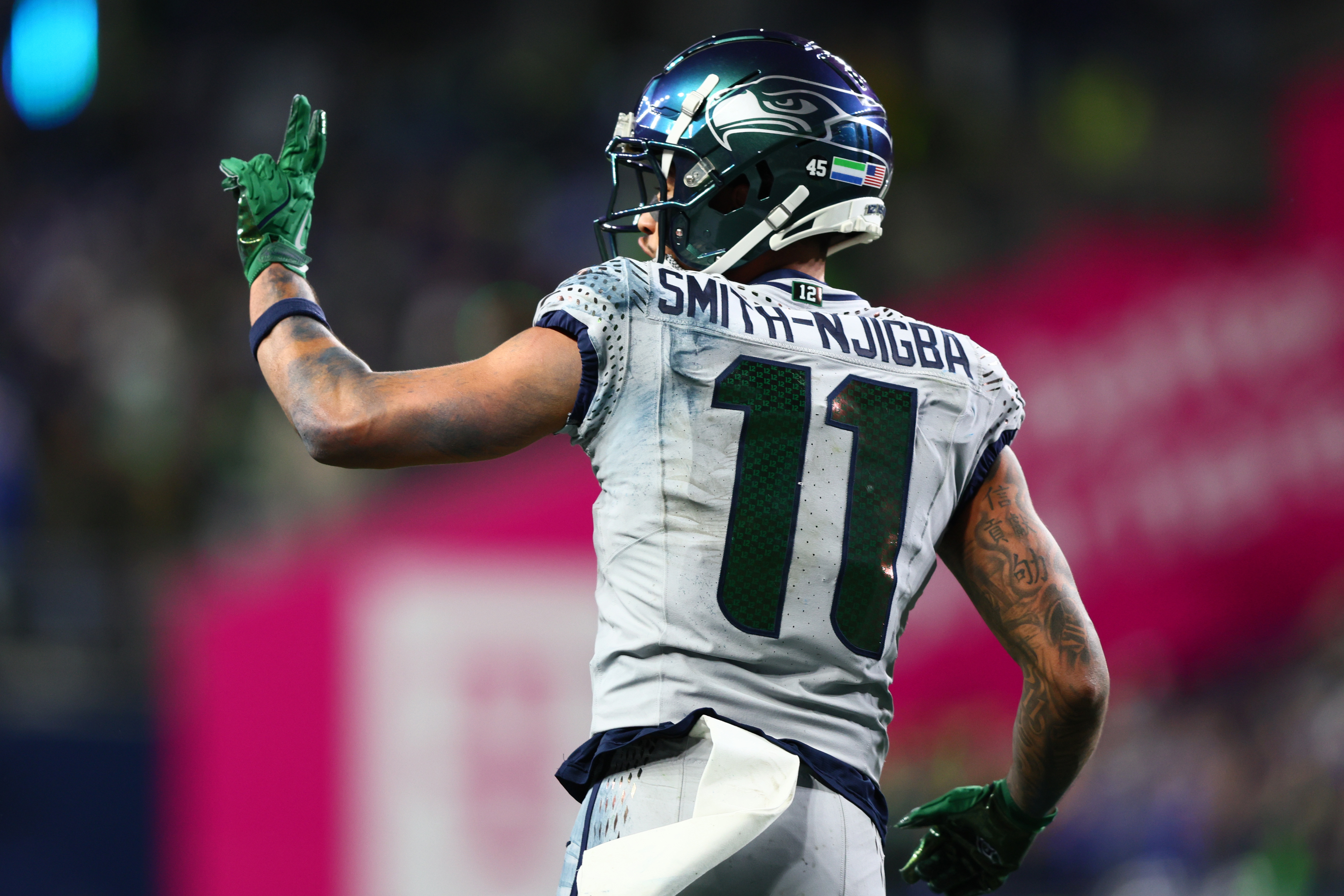 Seattle Seahawks wide receiver Jaxon Smith-Njigba (11) celebrates after scoring as we offer our Rams vs. Seahawks prediction for the NFC Championship.