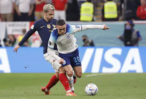 England midfielder Phil Foden and France forward Antoine Griezmann battle for the ball during the first half of a quarterfinal game in the 2022 FIFA World Cup, and we look at the top odds for Euro 2024.