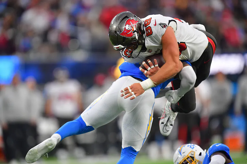 Tampa Bay Buccaneers tight end Cade Otton is tackled by Los Angeles Chargers safety Tony Jefferson as we look at the best Week 16 odds.