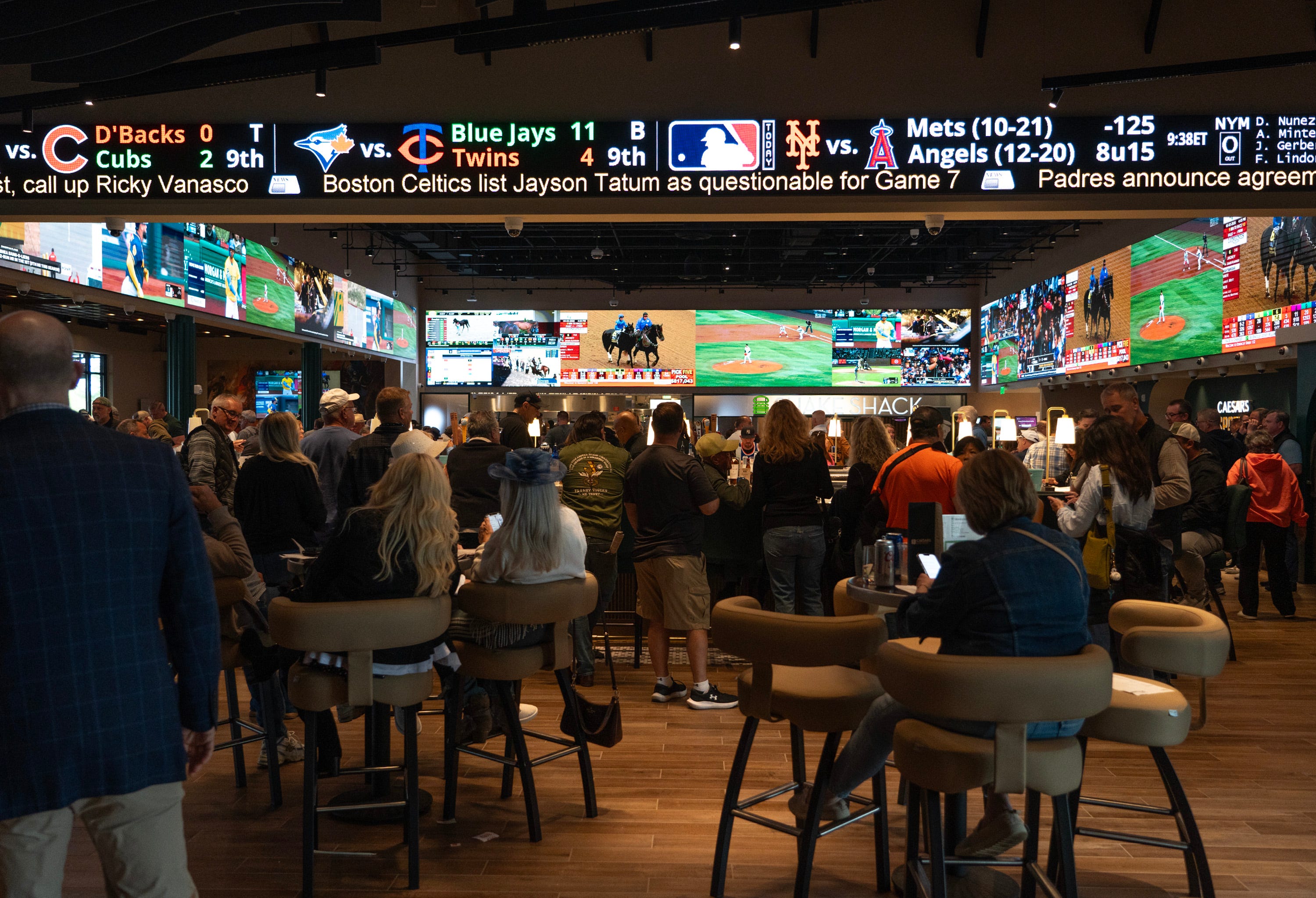 Horse racing fans gather at Monmouth Park for Kentucky Derby Day at Monmouth Park's First Turn Pavilion and Caesars Sportsbook.