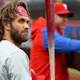 Philadelphia Phillies Bryce Harper stands in the hole during the first inning of a baseball game against the New York Mets as we look at our DraftKings promo code for Marlins-Phillies.