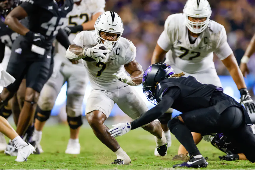 UCF Knights running back RJ Harvey breaks through the line of scrimmage as we offer our Colorado vs. UCF prediction for today's game.