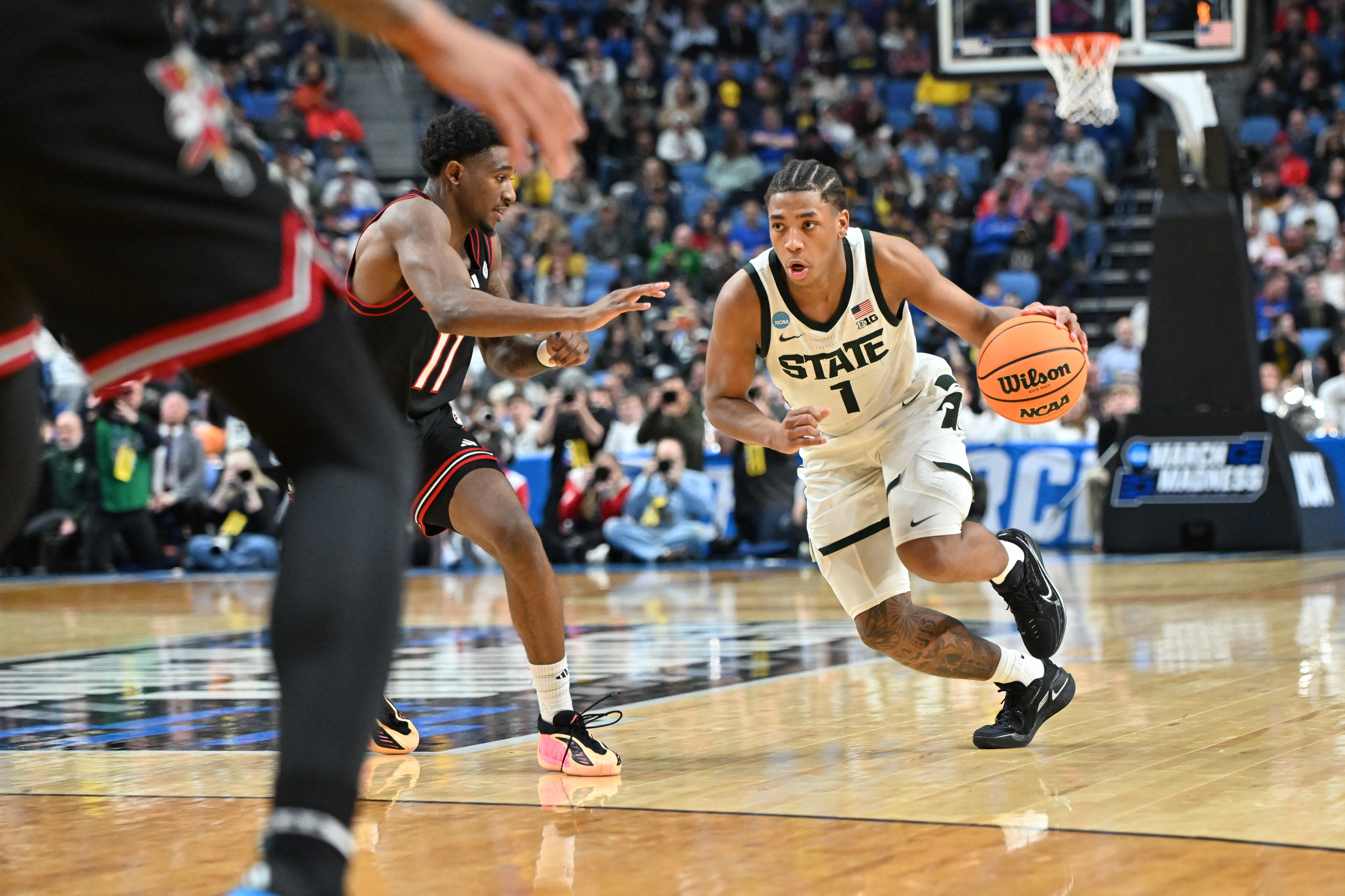 Jeremy Fears Jr. drives the ball as we provide our Michigan State vs. UConn prediction. 