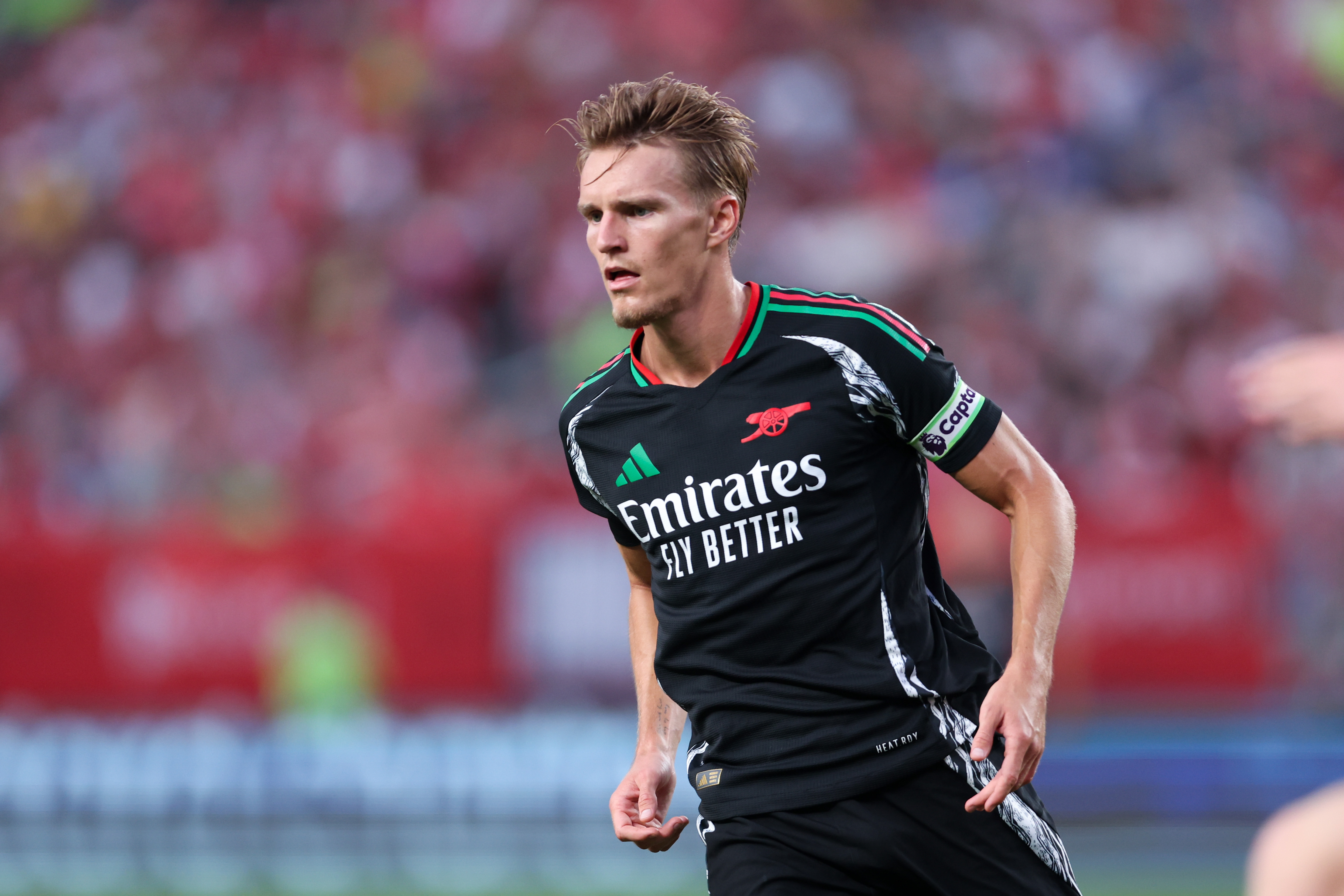 Arsenal midfielder Martin Odegaard in action as we make our best Arsenal vs. Liverpool predictions.