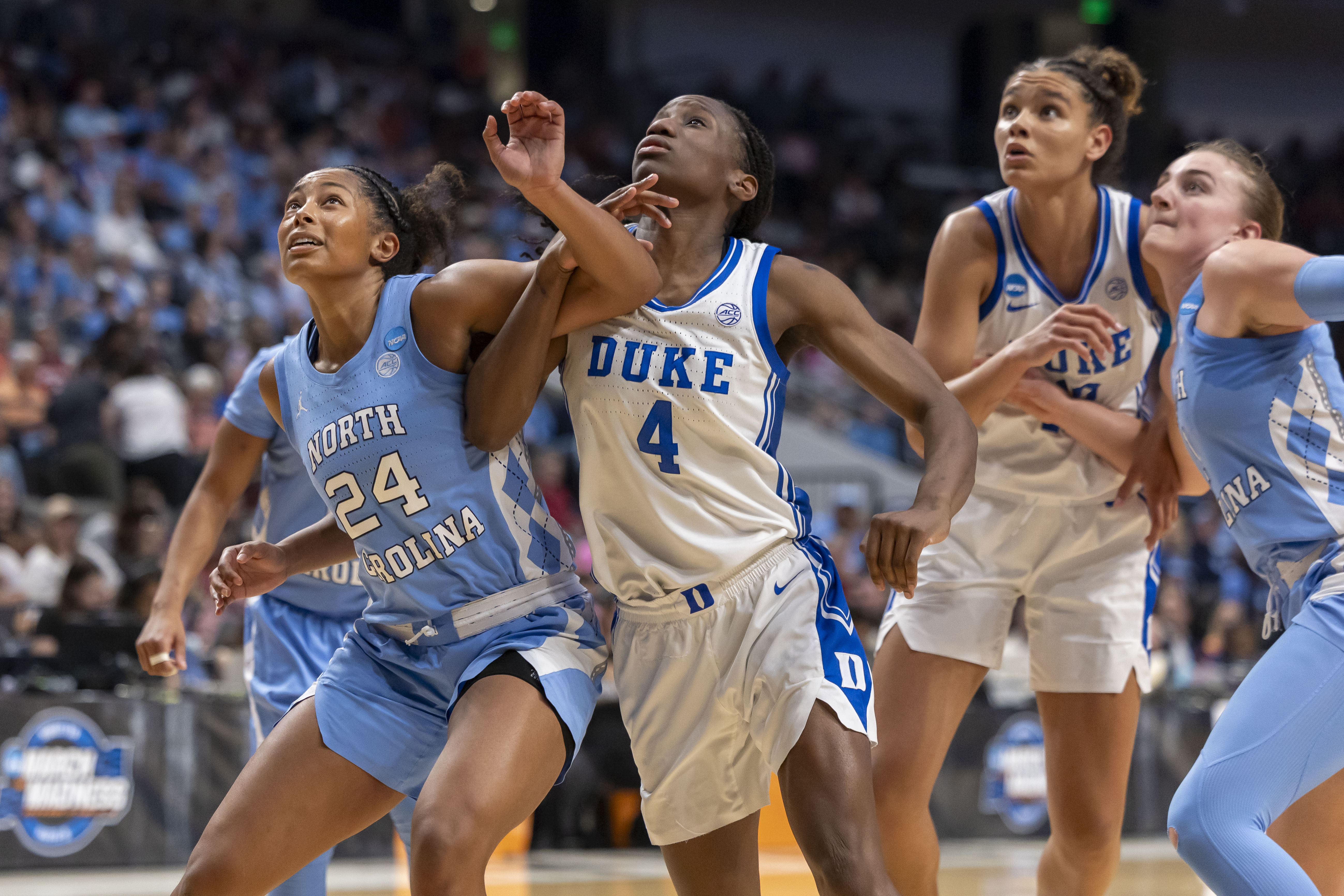 North Carolina and Duke players battle for a rebound as we provide our Duke vs. North Carolina prediction.
