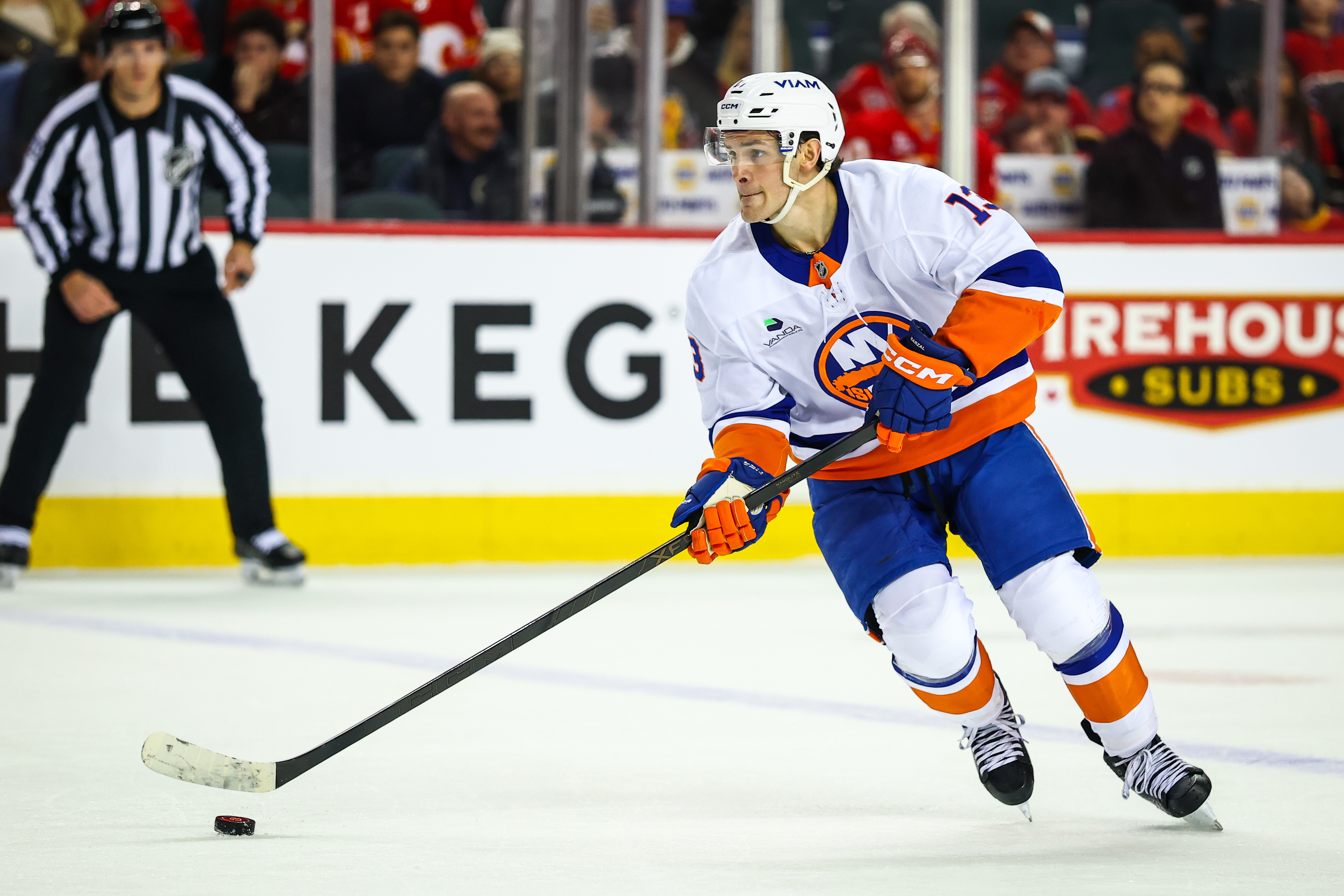 New York Islanders center Mathew Barzal (13) skates with the puck as we break down our Islanders vs. Kraken prediction, picks & best bets.