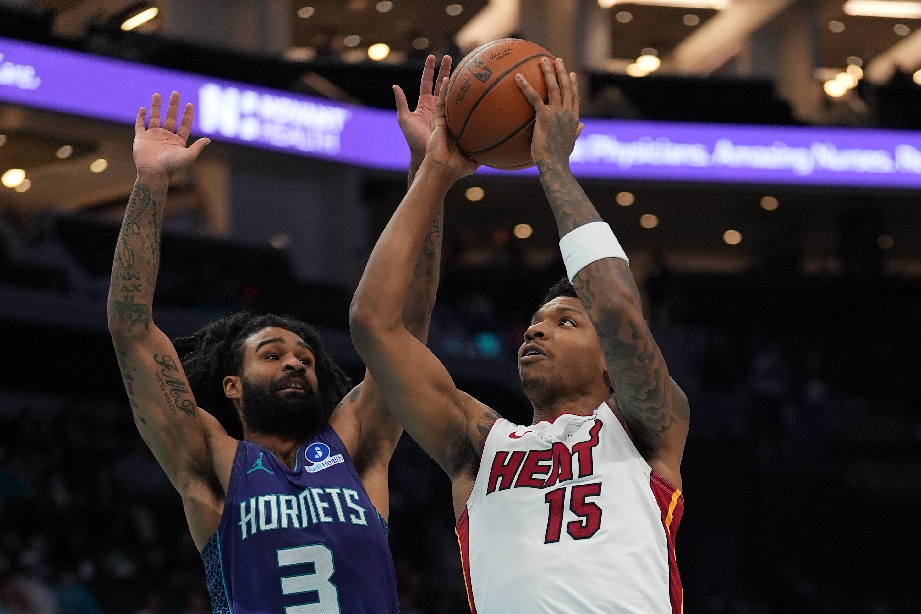 Miami Heat forward Myron Gardner is defended by Charlotte Hornets guard Coby White as we make our best Heat vs. Hornets prediction.