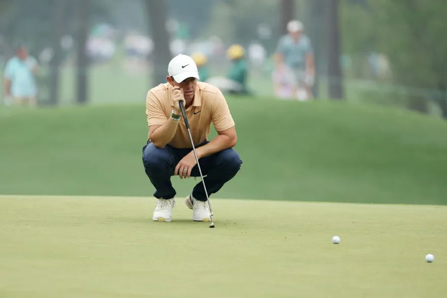 Rory McIlroy of Northern Ireland looks over a putt as we offer our Masters picks and predictions
