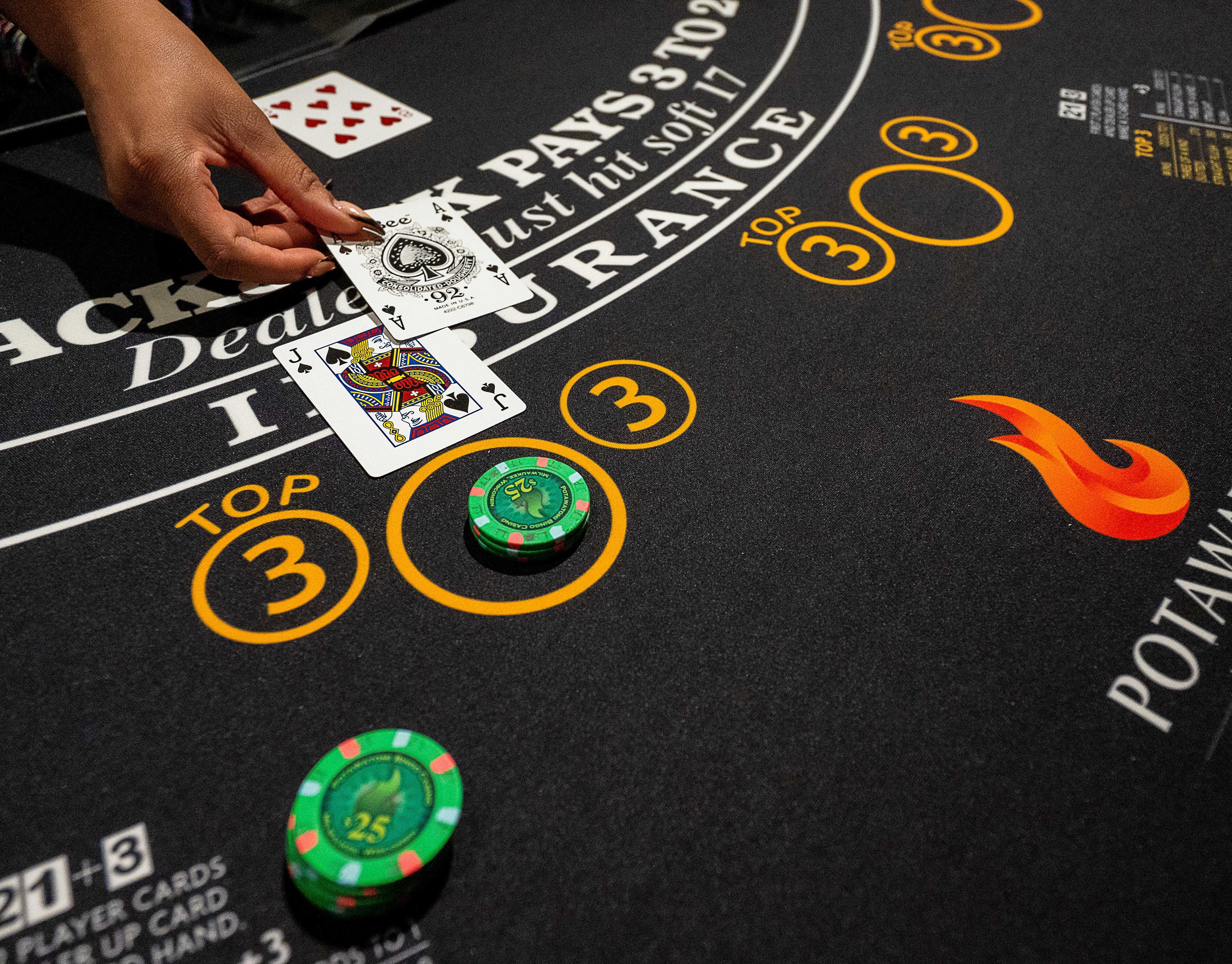 2023 09 08 T013604 Z 2135035412 M T1 Usatoda Y21364488 Rtrmadp 3 Table Games Dealer Uquasia Earth Places Cards on One of The