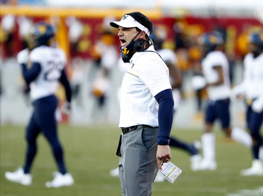 Head coach Neal Brown argues a call as we share our favorite West Virginia vs. Houston pick.