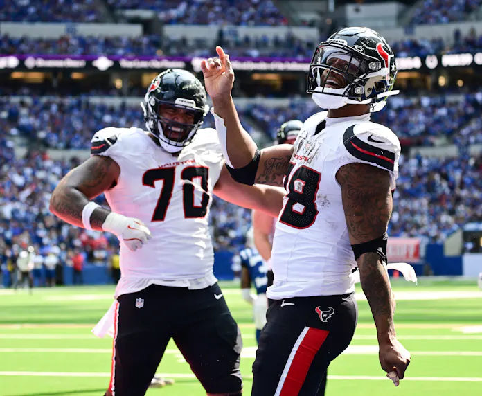 Houston Texans running back Joe Mixon celebrates a touchdown as we look at our best Bears vs. Texans SNF prop bets.