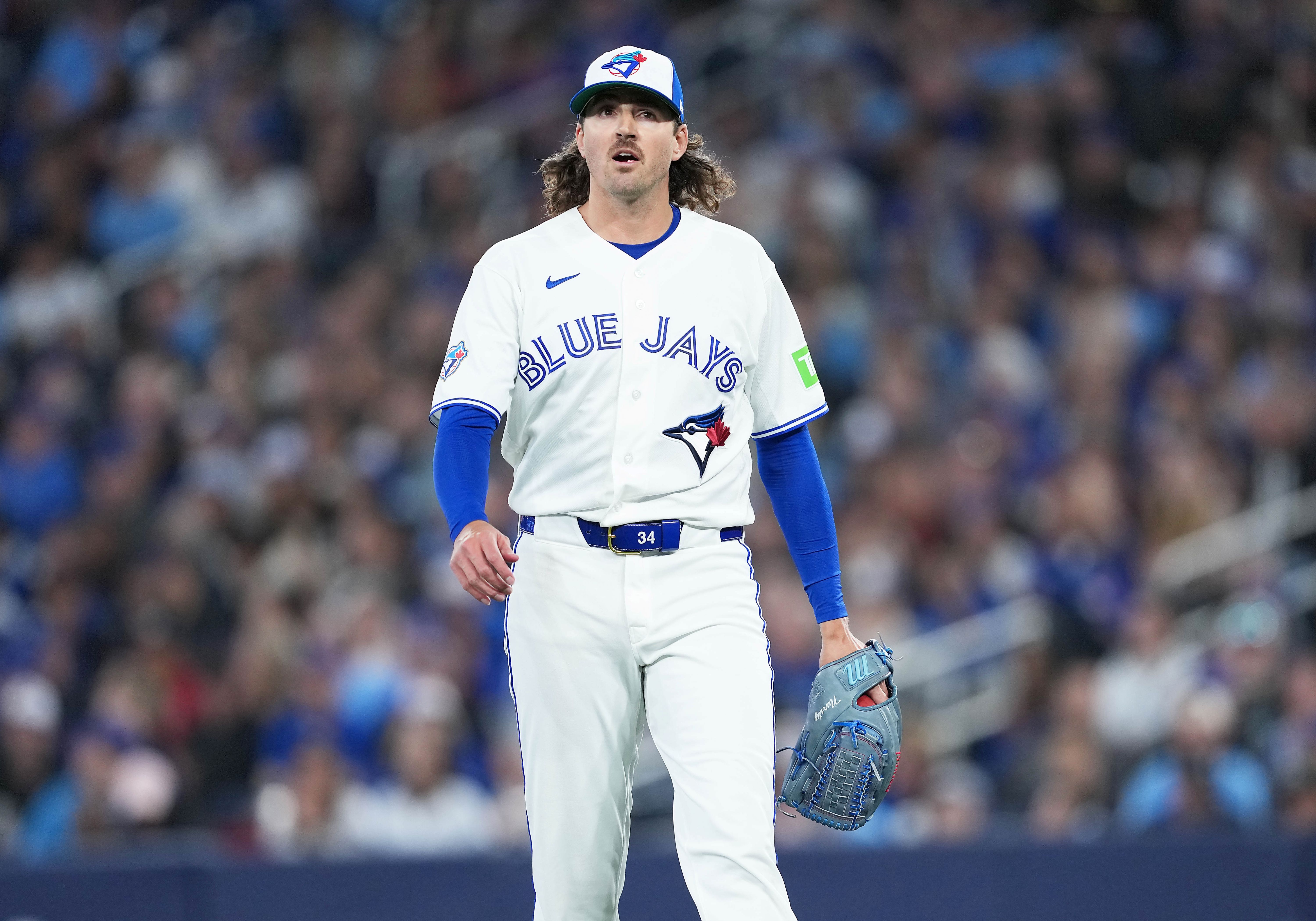 Toronto Blue Jays starting pitcher Kevin Gausman walks toward, and he's key as we look at our Dodgers vs. Blue Jays prediction