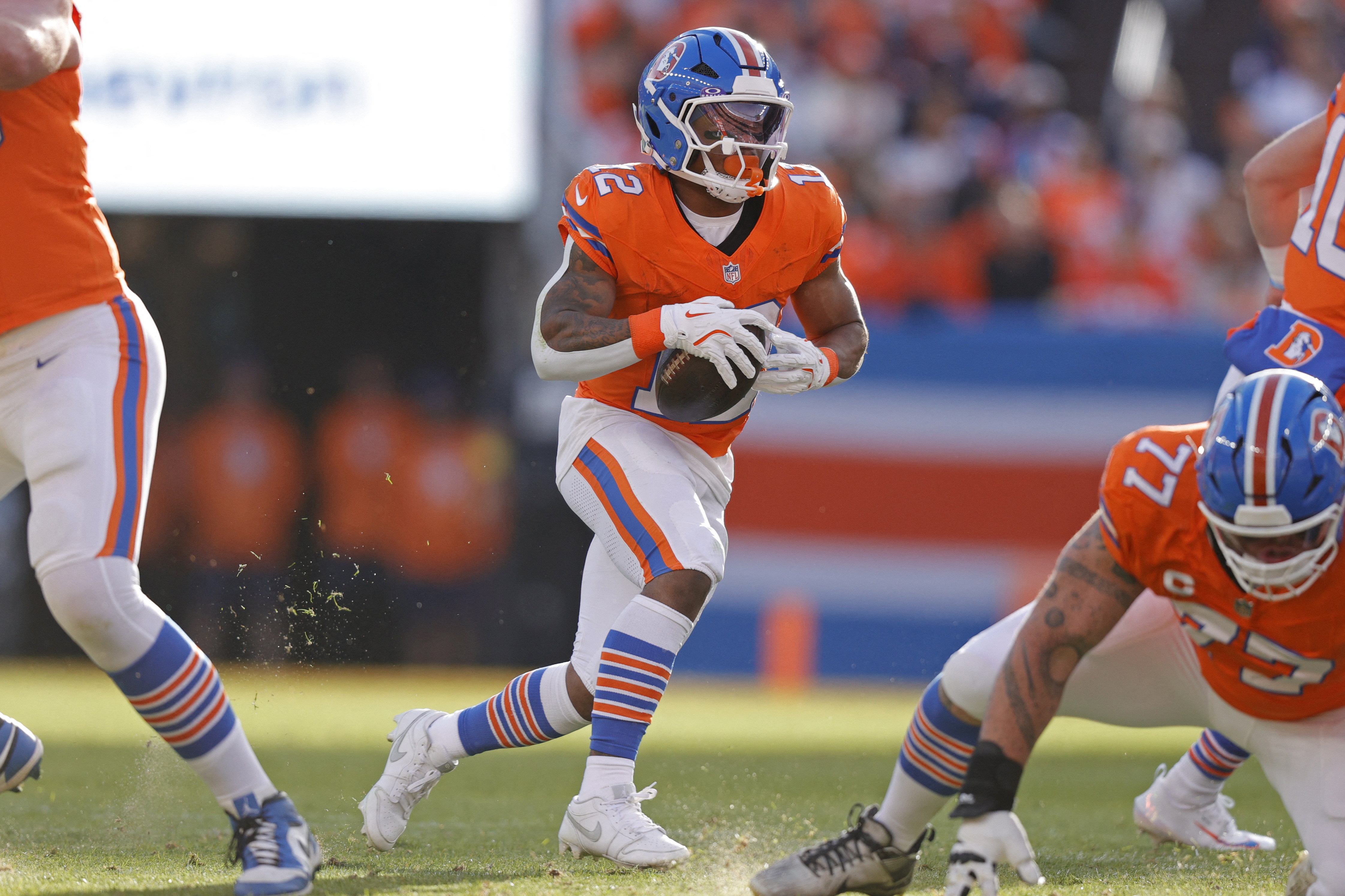 Denver Broncos running back RJ Harvey (12) runs with the ball as we look at our Bills vs. Broncos weather report for the Divisional Round