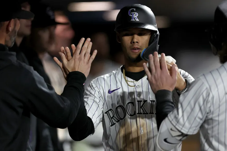 Ezequiel Tovar of the Colorado Rockies celebrates in the dugout after scoring on a Elias Diaz single against the Arizona Diamondbacks as we look at our Rockies-Blue Jays MLB player prop picks.