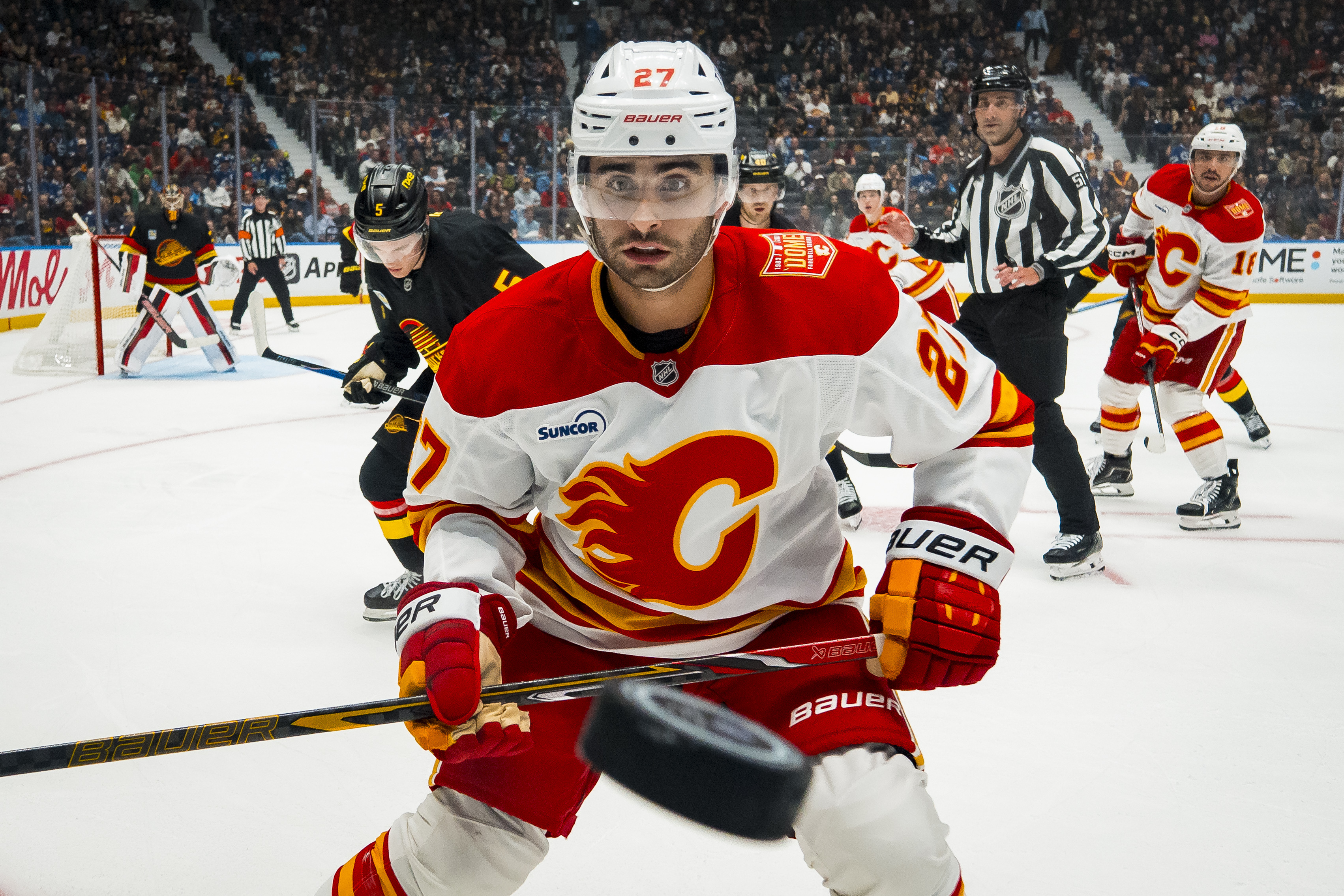 Calgary Flames forward Matt Coronato (27) watches the flying puck as we break down our NHL predictions today.