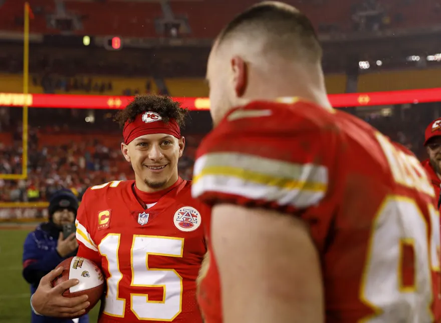 Patrick Mahomes of the Kansas City Chiefs smiles at Travis Kelce after defeating the Jacksonville Jaguars in the AFC Divisional Playoff game at Arrowhead Stadium on January 21, 2023 in Kansas City, Missouri.