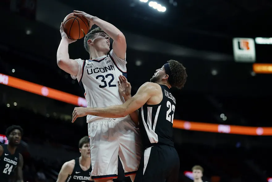 Donovan Clingan #32 of the UConn Huskies is fouled while shooting by Gabe Kalscheur #22 of the Iowa State Cyclones during the first half of the Phil Knight Invitational Tournament Men’s Championship at Moda Center on Nov. 27.