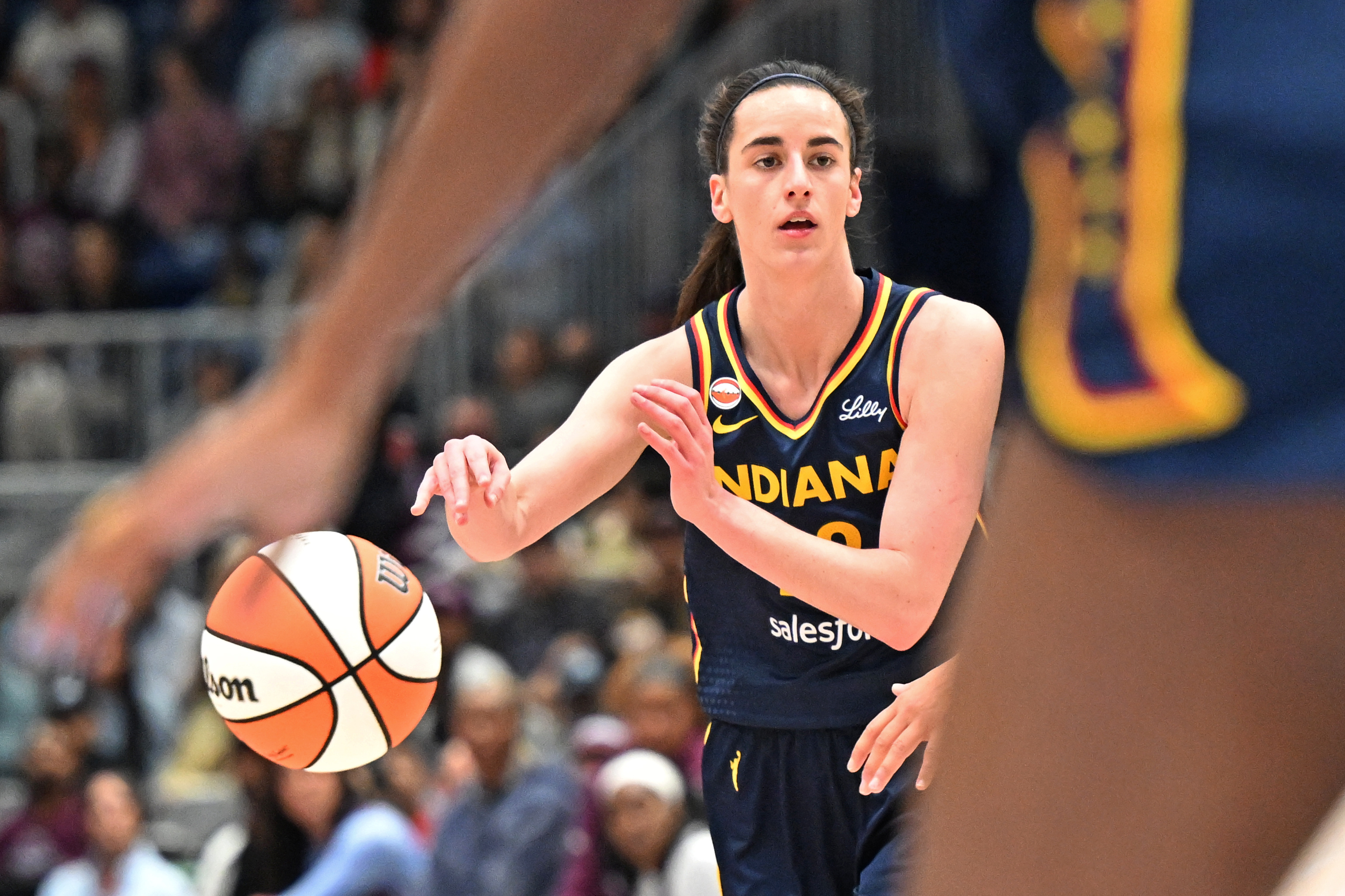 Indiana Fever guard Caitlyn Clark (22) passes the ball as she is featured in our Fever vs. Lynx prediction.