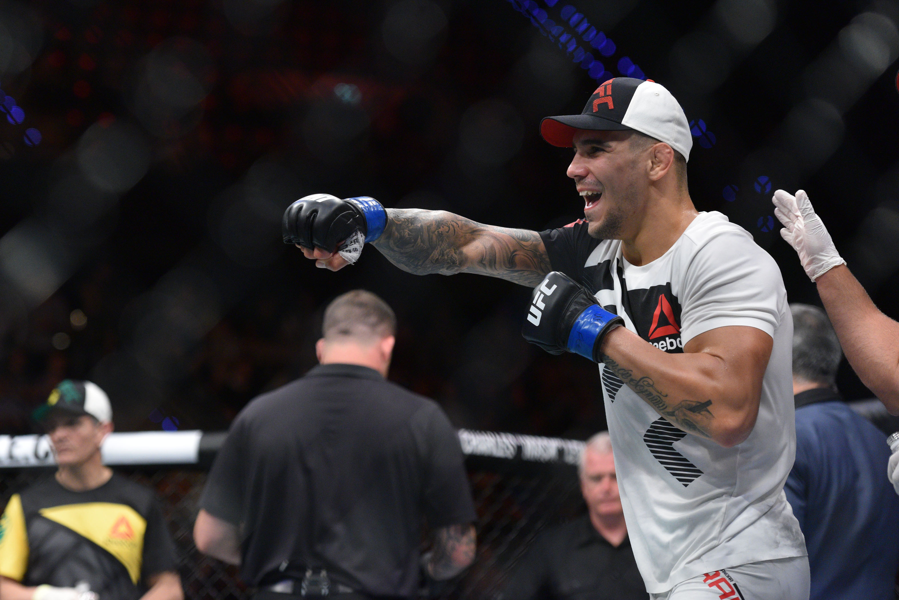 Aleksander Rakic (blue gloves) reacts to a fight as we make our best UFC 321 parlay picks. 