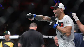 Aleksander Rakic (blue gloves) reacts to a fight as we make our best UFC 321 parlay picks.