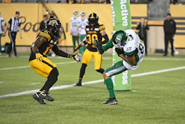 Saskatchewan Roughriders wide receiver Kian Schaffer-Baker catches a touchdown pass in front of Hamilton Tiger-Cats linebacker Kyle Wilson at Tim Hortons Field. We expect another high-scoring game in our Tiger-Cats vs. Roughriders Prediction.